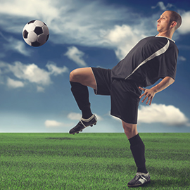 image of youth kickig soccer ball